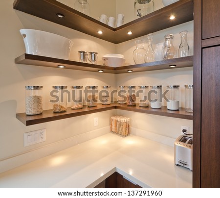 Fragment Of The Luxury Modern Kitchen With Some Shelves With Jars, Cans In The Corner. Interior Design.