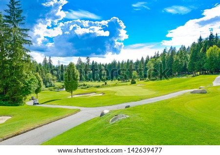 Beautiful golf course in a sunny day with dark blue sky and clouds. Canada, Vancouver. Vertical.