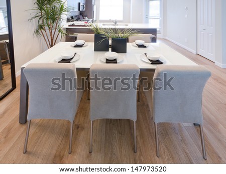 Nicely decorated and served living, lunch room table with the coffee, tea set and decorative vases. Interior design.