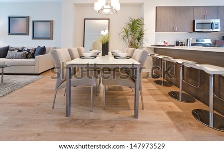 Luxury and nicely decorated living set, lunch room with the table with the coffee, tea set and the living suite, room and the kitchen aside . Interior design.