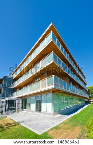 Perspective of the modern glass and steel building, house with balconies on perimeter.  Exterior design.