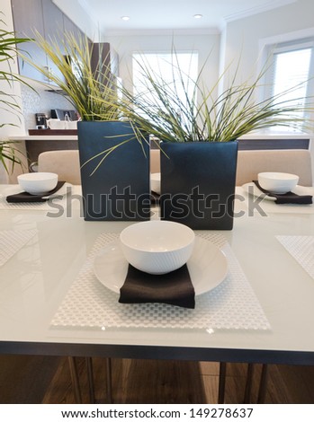 Nicely decorated and served living ( lunch ) room table with the coffee set and some vases. Interior design.