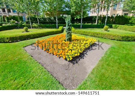 Landscape design.  Flower bed and nicely trimmed bushes in the park.  Vancouver. Canada.