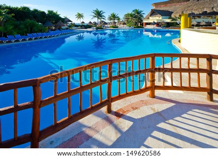 Traditional style wooden fence at the the swimming pool at the luxury mexican resort. Bahia Principe, Riviera Maya.