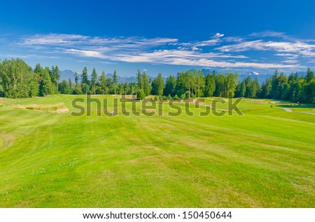 Panorama, outlook at the gorgeous golf course with a mountains and dark blue sky. Vancouver, Canada.