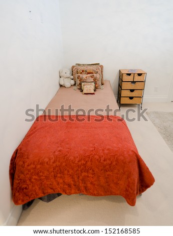 Kids bedroom with minimal design and beige walls.