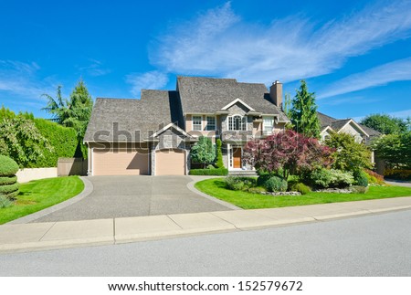 Big Custom Made Luxury House With Nicely Landscaped Front Yard And Long Driveway In The Suburbs Of Vancouver, Canada.
