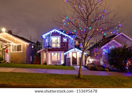 Houses, neighborhood decorated and lighted for Christmas and for New Year Eve . Night in Vancouver, Canada.