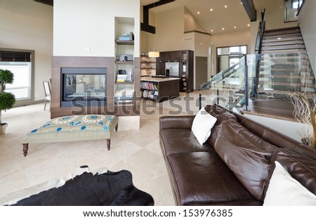 Outlook At The Luxury Spacious Modern Living Room With The Fireplace And Stairs To The Upper Level. Interior Design.