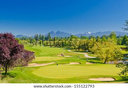 Great view, outlook, panorama at the beautiful golf course with the mountains at the back. Canada, Vancouver.