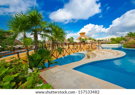 Bridge over of swimming pool at the luxury mexican resort. Bahia Principe, Riviera Maya.