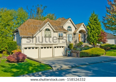 Big custom made luxury house with triple garage doors in the suburbs of Vancouver, Canada.