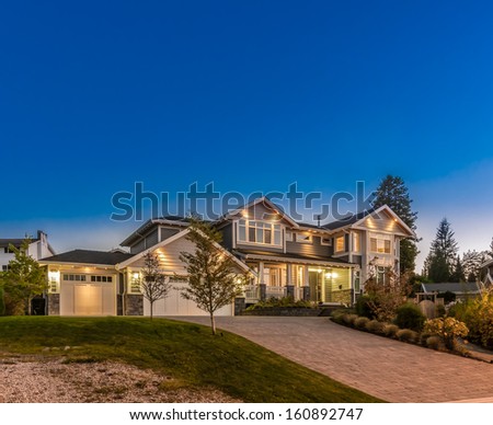Big luxury house at dusk, night, sunrise time in suburbs of Vancouver, Canada.