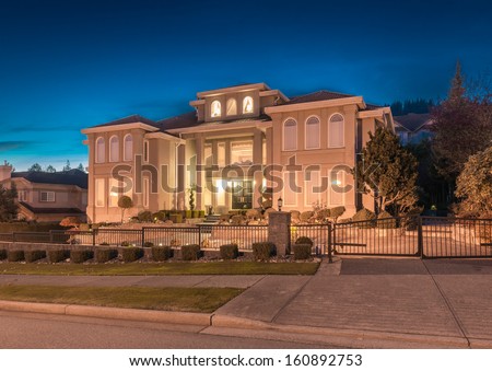 Big luxury house at night, dusk time in suburbs of Vancouver, Canada.