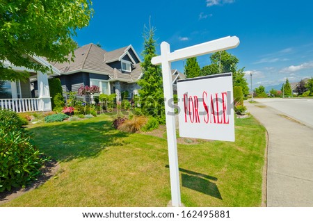 House, sign for sale for big custom made luxury house in the suburbs of Vancouver, Canada.