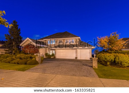 Big luxury house at dusk, night time in suburbs of Vancouver, Canada.
