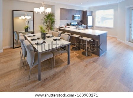 Luxury living suite : dining room and the kitchen at the back . Interior design.