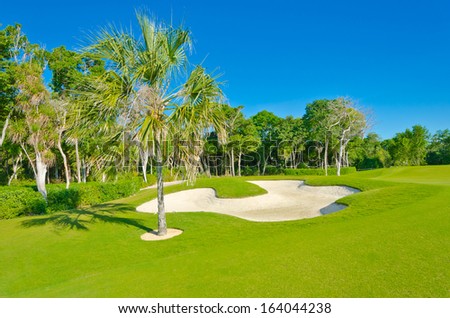 Sand bunker on the beautiful golf course. Mexican resort. Bahia Principe.  Riviera Maya.