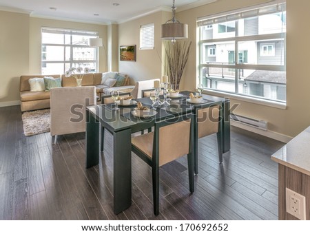 Outlook At The Luxury And Nicely Decorated Modern Living Set, Lunch, Dining Room With The Decorated Table With The Dinner Set And The Living Suite, Room . Interior Design Of A Brand New Townhouse.