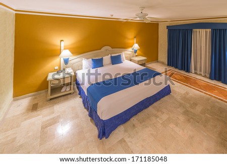 Modern comfortable and elegant master bedroom in a luxury resort hotel. Bahia Principe, Riviera Maya, Mexican Resort. Interior design.