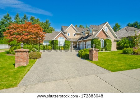 Big and wide driveway to the luxury custom made house with nicely landscaped front yard and double doors garage. Suburbs of Vancouver, Canada.
