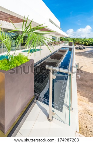 Perspective, outlook, panorama at the modern glass and steel balcony, deck, promenade railing and the water pool as an decor design. Exterior, interior design.