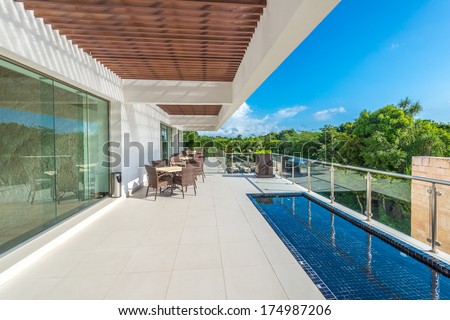 Perspective, outlook at the modern stylish restaurant, cafe, bar on the balcony, deck, patio of the luxury Mexican resort. Exterior, interior design.