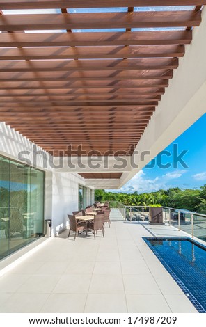 Perspective, outlook at the modern stylish restaurant, cafe, bar on the balcony, deck, patio of the luxury Mexican resort. Exterior, interior design. Vertical.