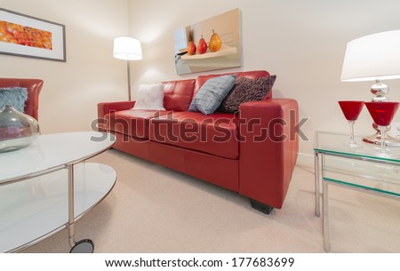 Luxury Living Suite Of Brand New House. Nicely Decorated Modern Family, Living Room With Red Color Couch, Chair And Coffee Table. Interior Design.