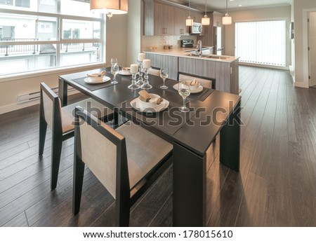 Outlook, Panorama At Luxury Living Site. Nicely Decorated Dining Table And Kitchen At The Back. Interior Design Of A Brand New House.
