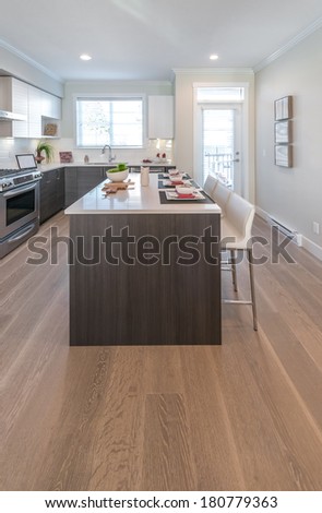 Interior design of a luxury modern kitchen with nicely decorated and served island table.