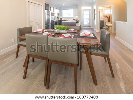 Perspective, outlook at the luxury living suite : nicely decorated dining table and the kitchen at the back. Interior design.