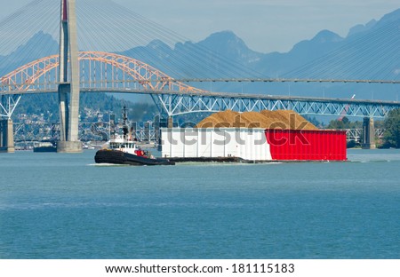 A tug boat towing barge loaded with cargo. Vancouver, Canada.