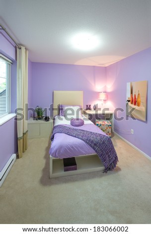 Modern comfortable, nicely decorated children bedroom painted in purple. Interior design.