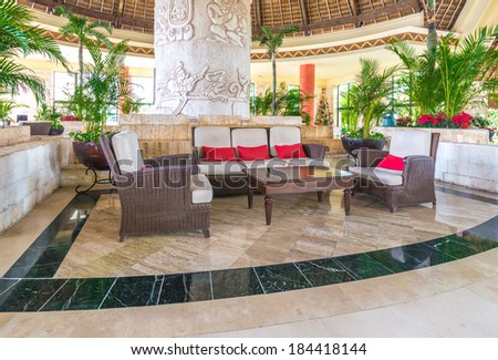 Fragment of the lobby, lounge area with some chairs and table of five stars luxury caribbean resort hotel. Interior design. Bahia Principe, Riviera Maya, Mexico.