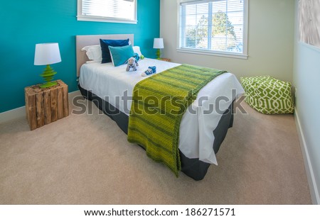 Modern nicely decorated bedroom for children painted in turquoise. Interior design.