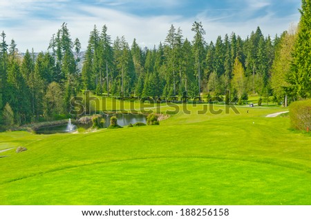 Panorama, outlook at the beautiful golf course in a sunny day with dark blue sky and clouds. Canada, Vancouver.