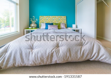 Modern comfortable, nicely decorated bedroom painted in blue Interior design.
