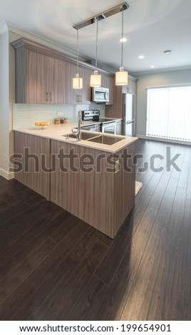 Luxury modern kitchen in a brand new house. Interior design. Vertical.