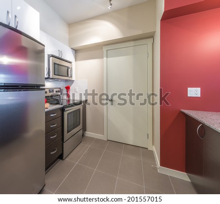 Fragment of the nicely decorated luxury kitchen with modern appliances. Interior design.