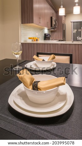 Napkins on the nicely decorated and served dining table. Interior design of a brand new house.