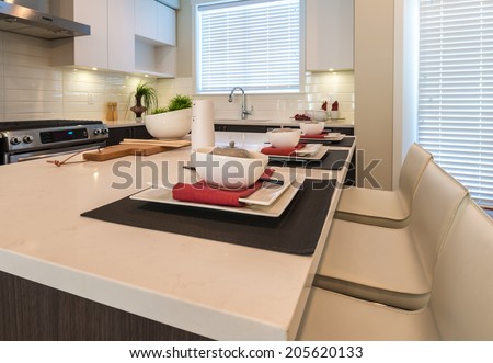 Outlook at the luxury modern living suite : living room with modern chair and dining suite and the kitchen at the back.  Interior design of a brand new house.