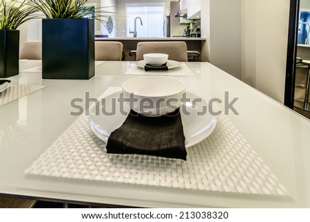 Nicely decorated dining table with cup, plate and napkin. Interior design.