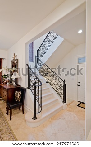 Stairs and handrail leading to the upper, low level. Interior design.