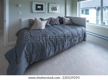 Luxury nicely decorated modern bedroom.  Interior design of a brand new house.