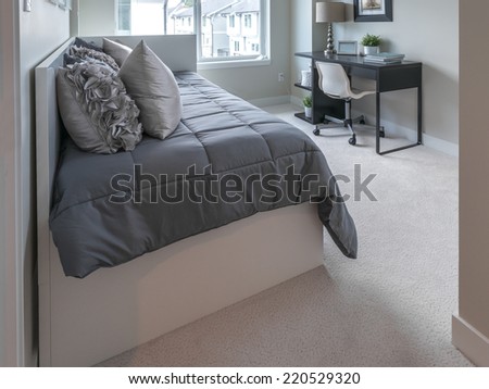 Luxury nicely decorated modern comfortable bedroom.  Interior design of a brand new house.