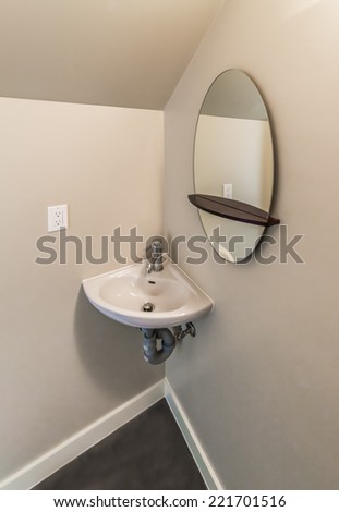 Fragment of a bathroom, washroom with wash basin, sink and the mirror. Interior design.