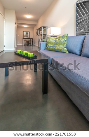 Modern living room with the couch and the candles on the coffee table. Interior design. Vertical.