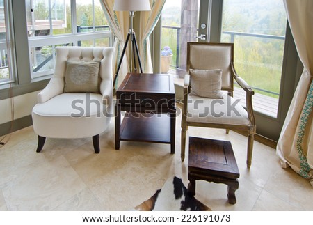 Outlook at the luxury spacious modern living room with the leather sofa, coach and chairs. Interior design.