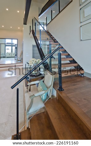 Wooden stairs to the upper level. Interior design. Vertical.g